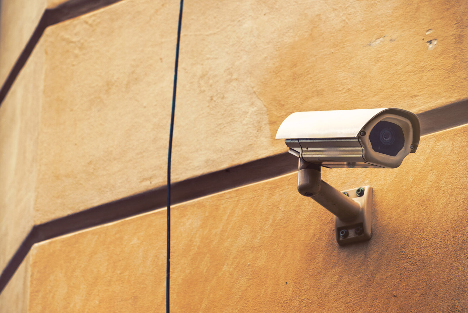 Security camera mounted on a sandstone wall